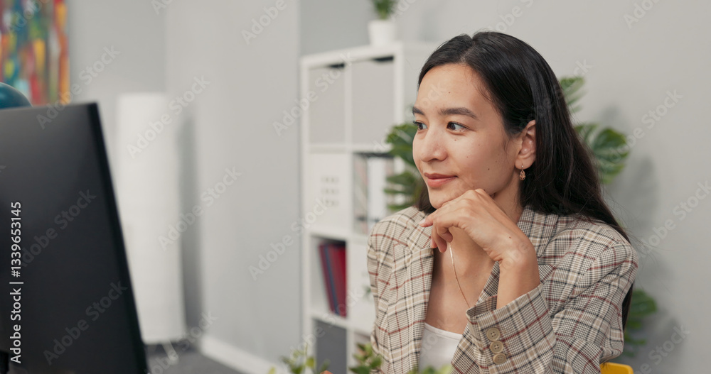 A focused pretty woman with long brown hair wearing a checkered jacket sits at desk in office in front of computer screen, reading news, articles, documents, analyzing propping hand under chin, smiles A focused pretty woman with long brown hair wearing a checkered jacket sits at desk in office in front of computer screen, reading news, articles, documents, analyzing propping hand under chin, smiles