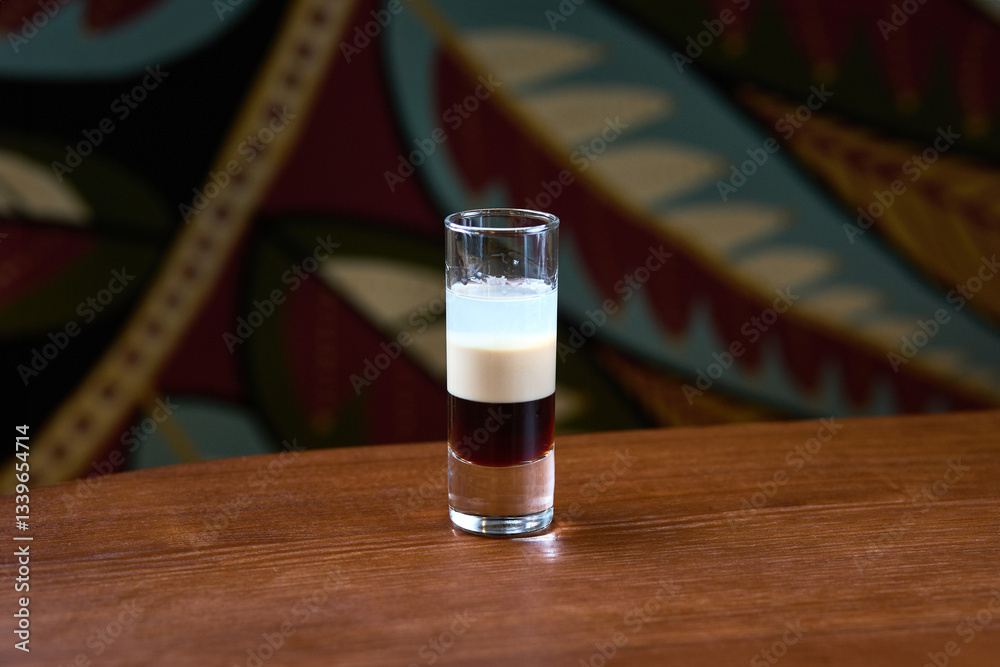 Layered Espresso Martini in a Shot Glass on Wooden Table