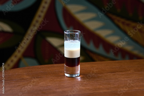 Layered Espresso Martini in a Shot Glass on Wooden Table