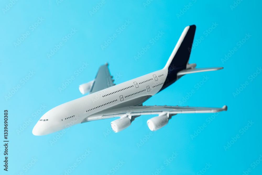 Plane model in air on light blue background, closeup Plane model in air on light blue background, closeup
