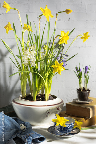 Spring flowers in a vintage soup tureen on a rustic setting photo