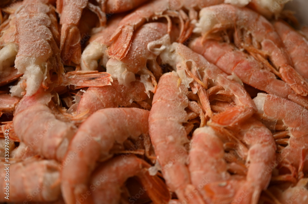 close-up of red tails of frozen shrimps, texture of frozen shrimps as background macro close-up of red tails of frozen shrimps, texture of frozen shrimps as background macro
