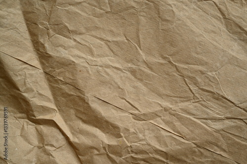 brown crumpled paper texture as background, old kraft paper as background, crumpled packing material texture as background photo above