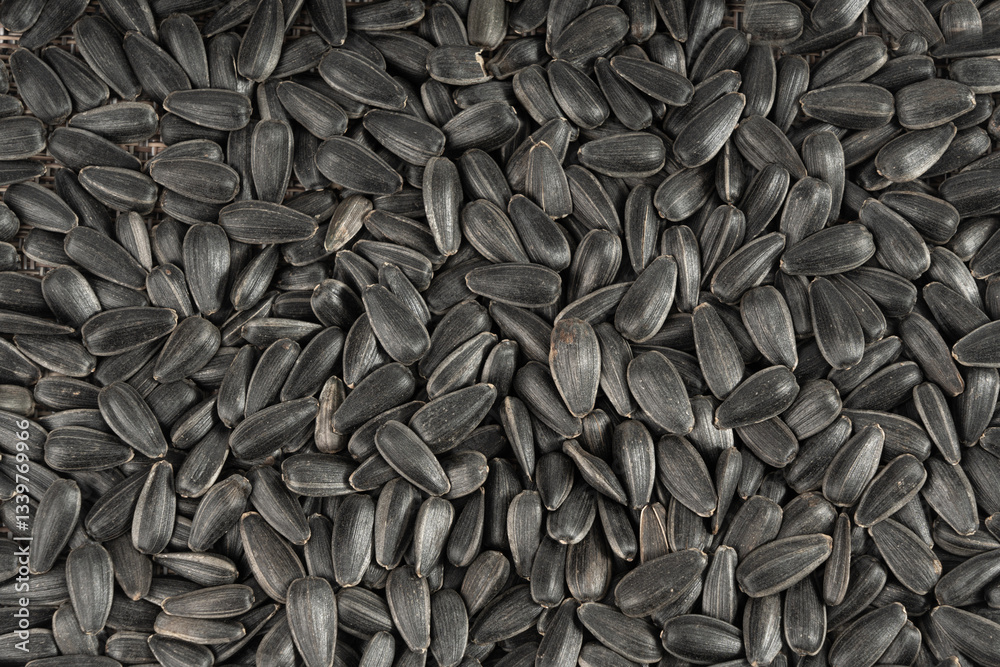 Sunflower seeds texture background, black sun flower grains snack pattern, edible oil kernels