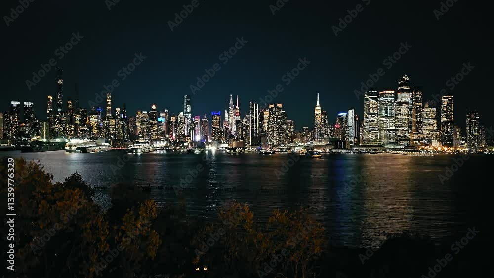 Nighttime Manhattan skyline with illuminated skyscrapers reflecting on the Hudson River, stunning cityscape Nighttime Manhattan skyline with illuminated skyscrapers reflecting on the Hudson River, stunning cityscape