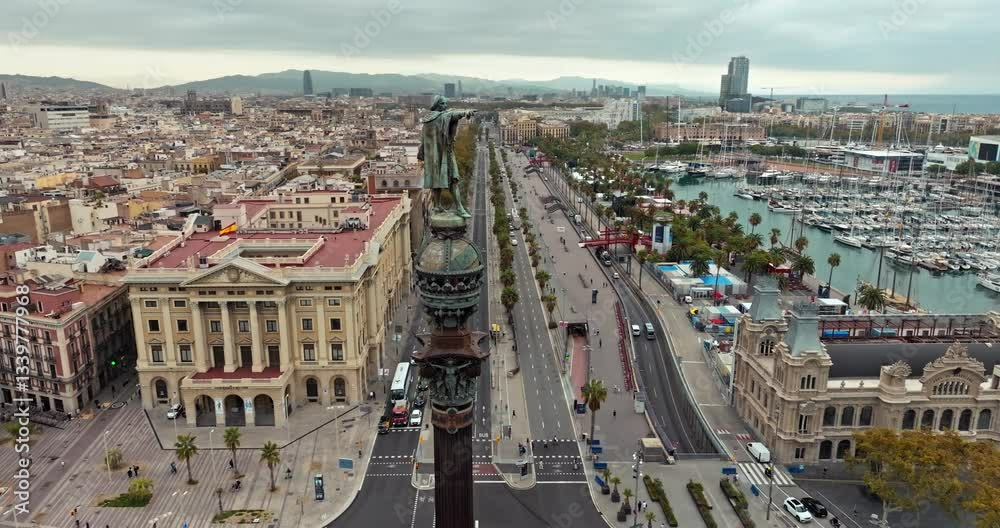 Aerial view of Barcelona Placa de les Drassanes: Scenic port with moored boats, cars on the bustling highway, and the dynamic urban atmosphere of Catalonia, Spain. High quality 4k footage