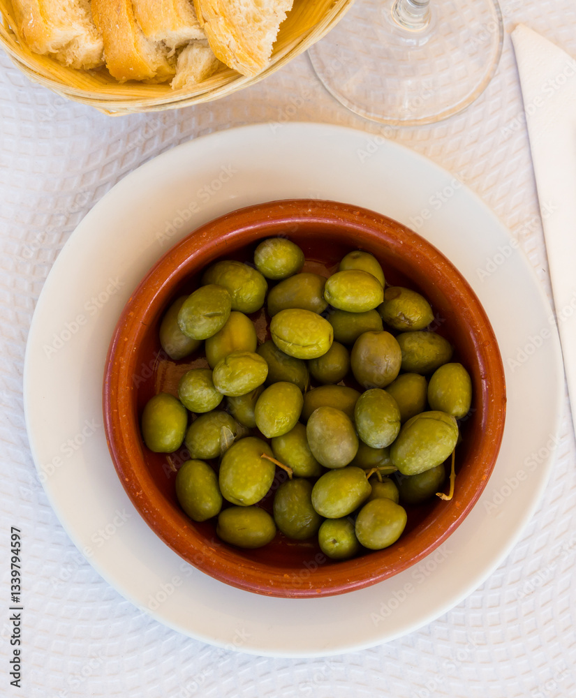Clay bowl of green olives - tasty snack