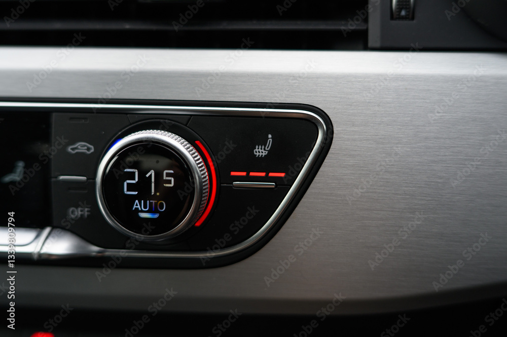 A car's dashboard has a temperature gauge that reads 21.5 with lit up heated seats button A car's dashboard has a temperature gauge that reads 21.5 with lit up heated seats button