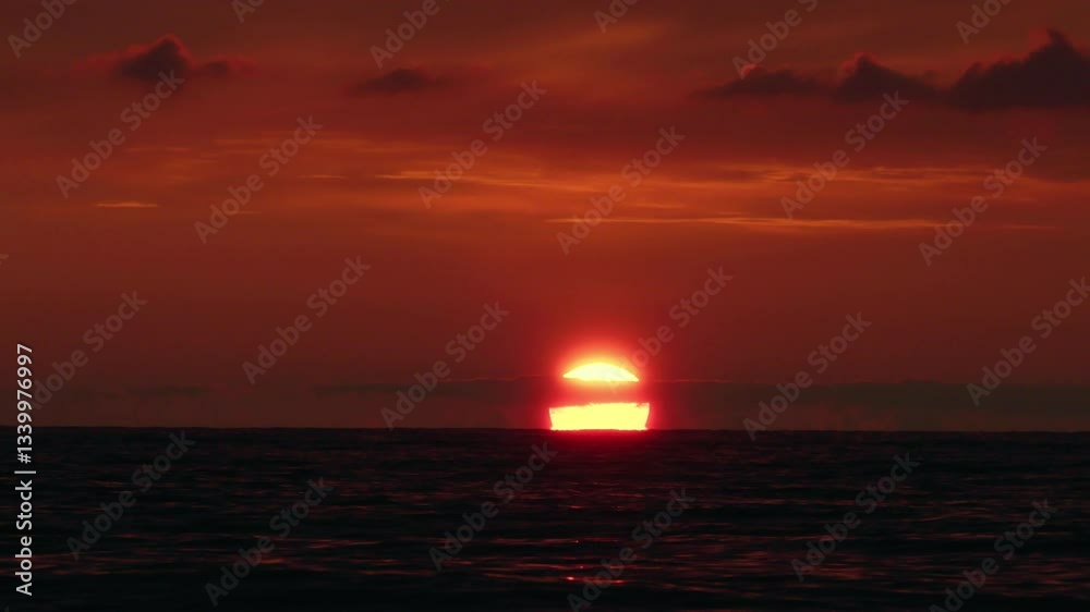 Breathtaking orange sunset over the sea, with vibrant hues of orange and reflecting on calm waves. Perfect for themes of serenity, travel, and natural beauty. Sunset over the water in slow motion Breathtaking orange sunset over the sea, with vibrant hues of orange and reflecting on calm waves. Perfect for themes of serenity, travel, and natural beauty. Sunset over the water in slow motion