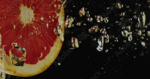 Closeup view of a Vibrant Citrus Fruit set against a contrasting Dark Background surface