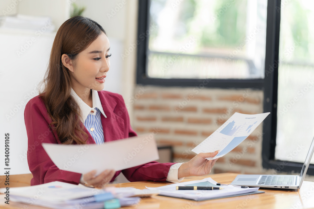 Beautiful business Asian woman with suit working at office table using laptop computer with copy space. Businessman, freelance employee, online marketing Beautiful business Asian woman with suit working at office table using laptop computer with copy space. Businessman, freelance employee, online marketing