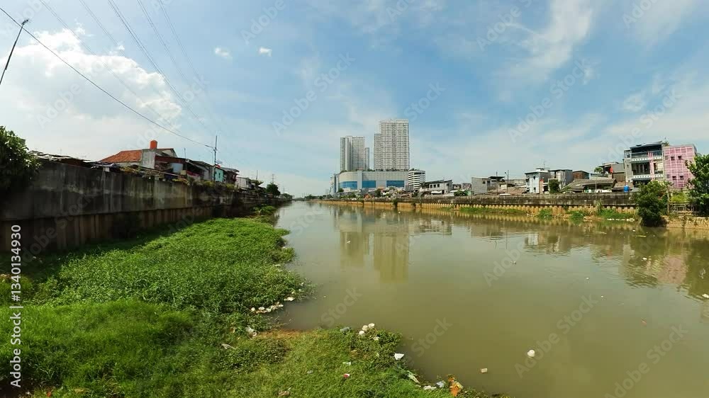 One of the dirty rivers of Asia in the city of Jakarta. The Ciliwung river is polluted with household waste and rubbish in the slums. Indonesia.