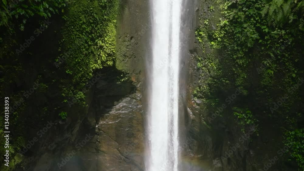 Aerial view of Waterfall in the green forest. Slow motion. Casaroro Falls in the jungle. Negros, Philippines. Aerial view of Waterfall in the green forest. Slow motion. Casaroro Falls in the jungle. Negros, Philippines.
