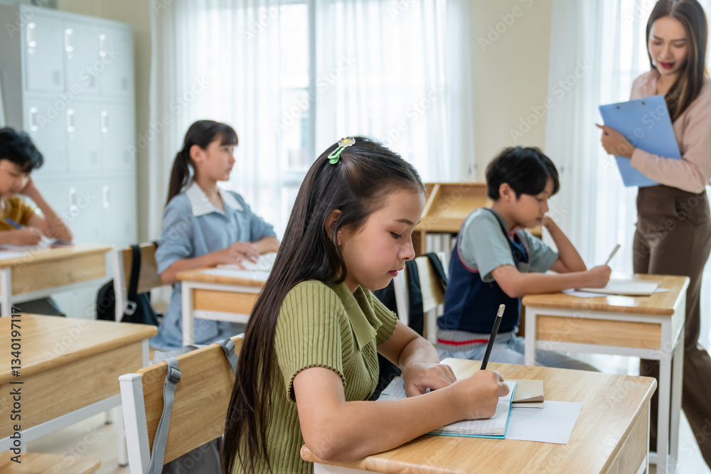 Group of students learning with teacher in classroom at elementary school. Group of students learning with teacher in classroom at elementary school.