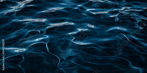 Fototapeta Naklejka Na Ścianę i Meble -  Dark blue water surface with gentle ripples reflecting light