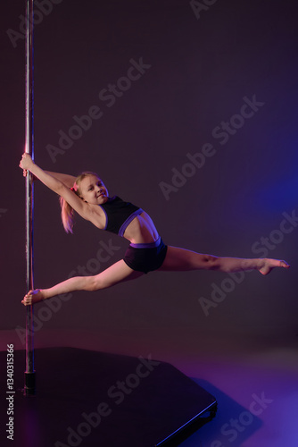 Girl performs impressive pole dance pose with elegant fabric style