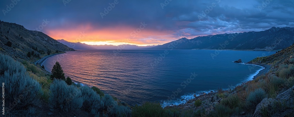 Obraz premium Lakeside sunset landscapes idea. A stunning sunset over a calm lake surrounded by mountains and lush greenery.