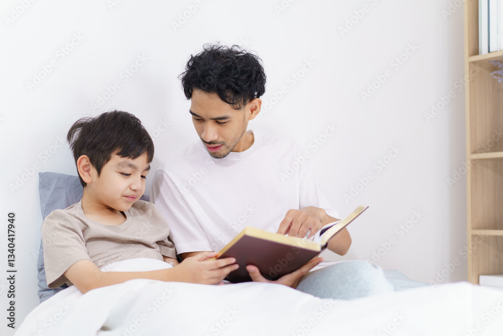 Asian father and son are learning the Quran together in morning. Asian father and son are learning the Quran together in morning.