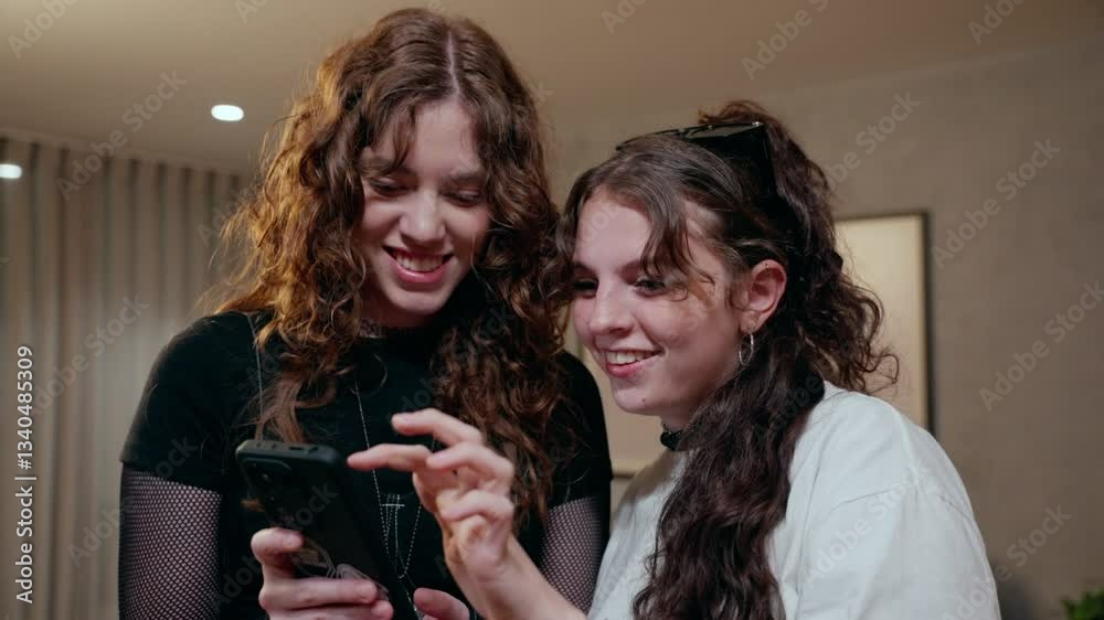 Two Young Women Using Smartphone Together Two Young Women Using Smartphone Together