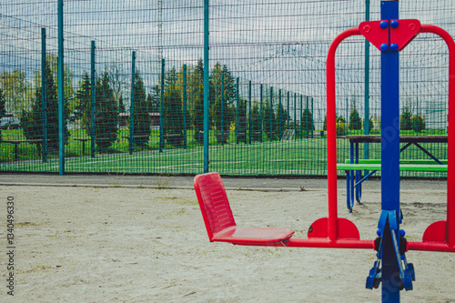 Outdoor playground with simulators. A football field enclosed mesh