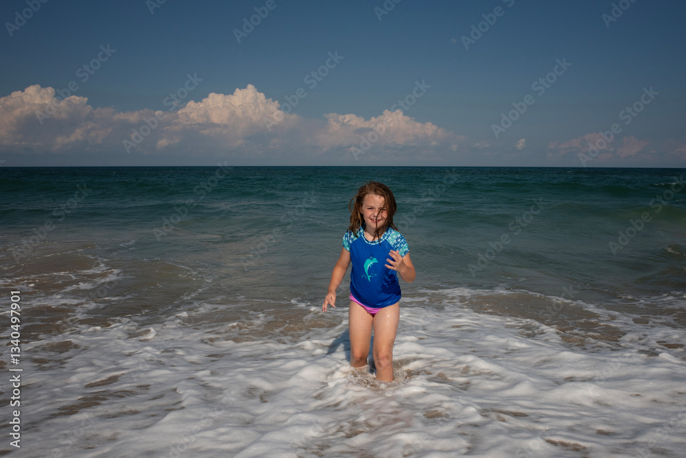 Smiling young girl playing in waves Outer Banks Smiling young girl playing in waves Outer Banks