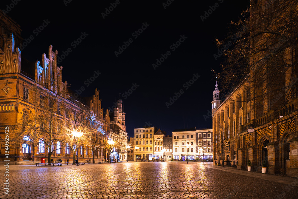 Fototapeta premium Vibrant night life illuminates the historic Old Town Square in Torun, Poland