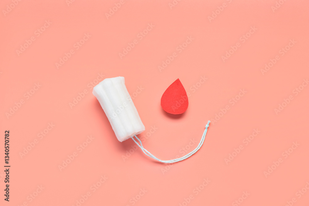 Obraz premium Composition with menstrual tampon and blood drop made of paper on coral background