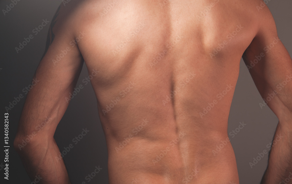 Fototapeta premium young man suffering in the pain. back view.