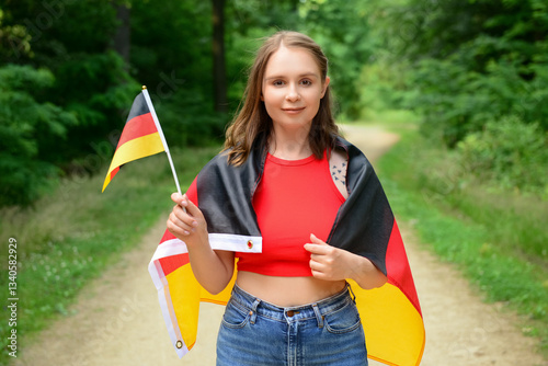 Young woman with flag of Ge...