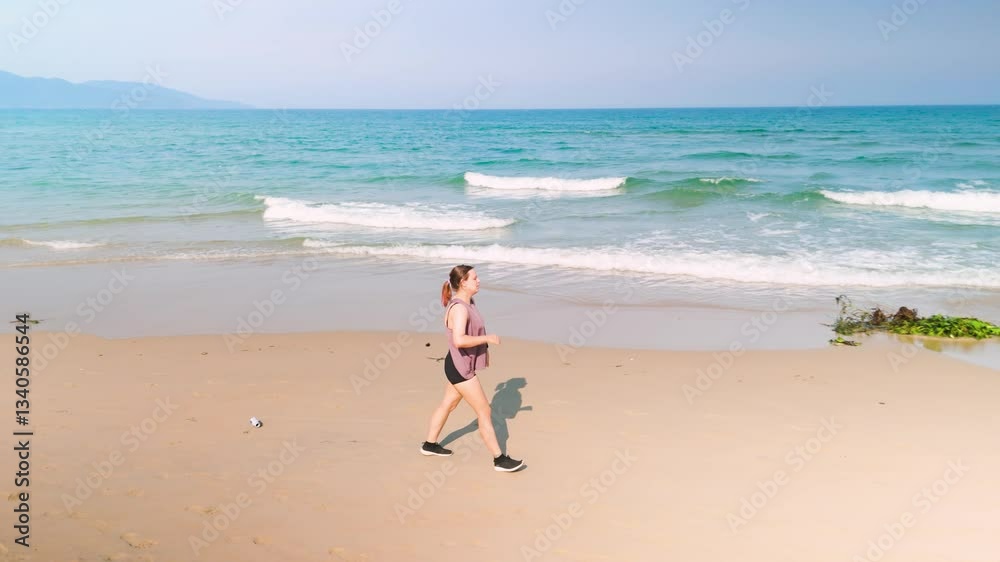 Athletic woman stretching on sandy beach, facing ocean waves, embodying wellness and coastal fitness during sunny summer day Athletic woman stretching on sandy beach, facing ocean waves, embodying wellness and coastal fitness during sunny summer day