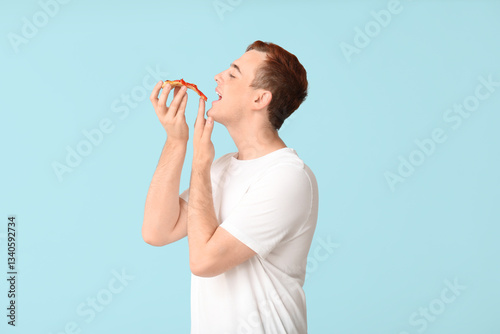 Young man eating piece of t...