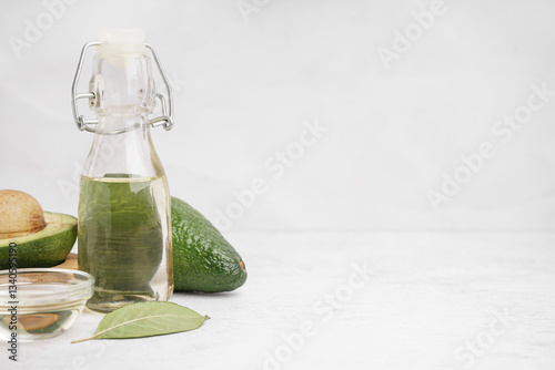 Fresh avocados, glass bottl...