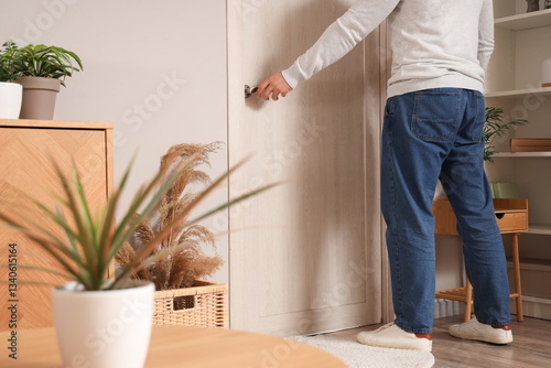 Young man opening door in l...