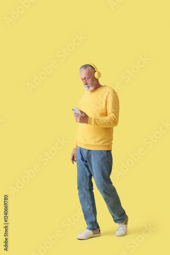 Mature man in headphones wi...