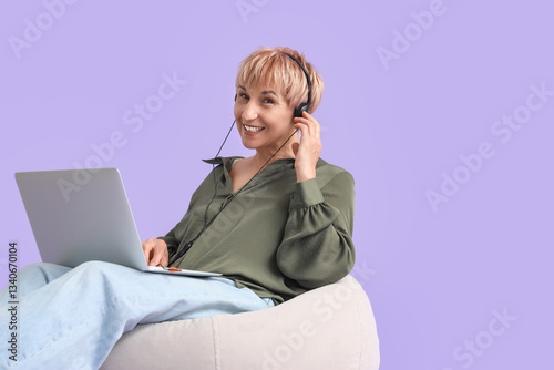 Mature woman in headphones ...