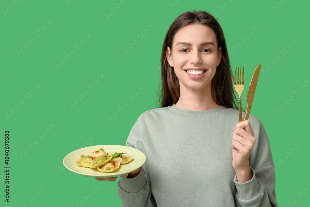 Beautiful young woman with plate of tasty ravioli and cutlery on green background Beautiful young woman with plate of tasty ravioli and cutlery on green background