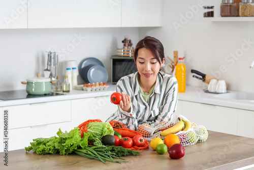 Young Asian woman with toma...