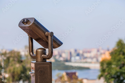 Binoculars on an observation deck overlooking the navigable Volga River in Nizhny Novgorod.