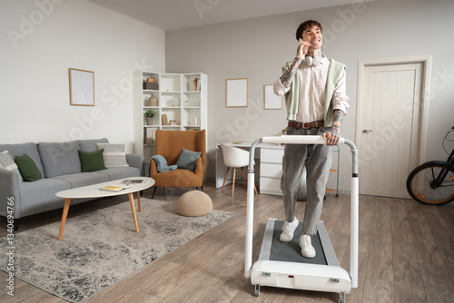 Young man exercising on tre...