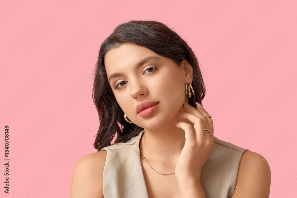 Fashionable young woman in beautiful jewelry on pink background Fashionable young woman in beautiful jewelry on pink background