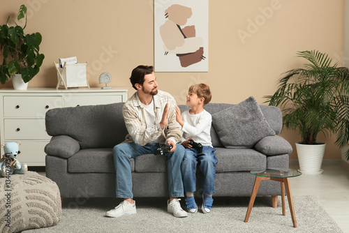 Dad and his little son play...