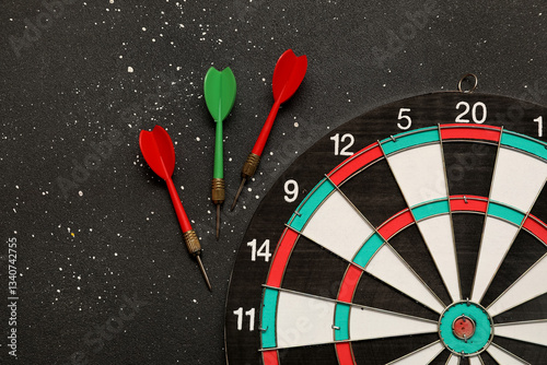 Darts with dartboard on black grunge background