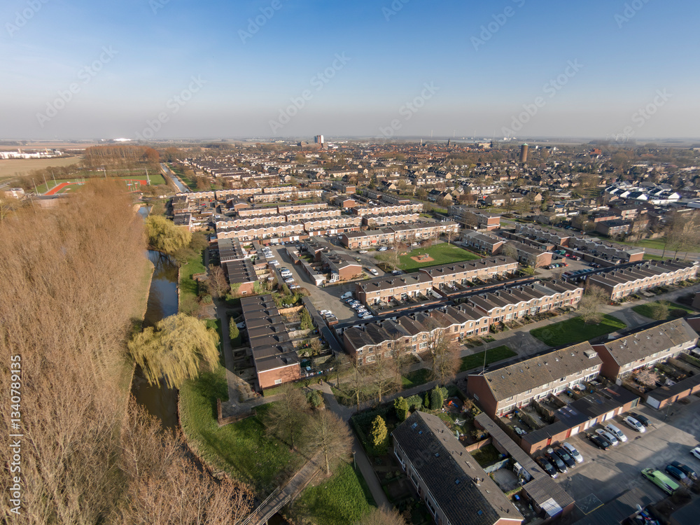 Fototapeta premium Urban landscape showcasing residential area and river in a clear sky during afternoon
