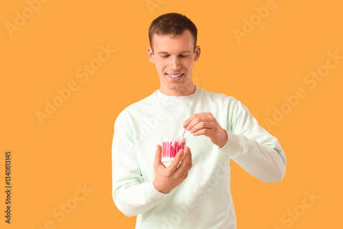 Young man with cotton buds ...