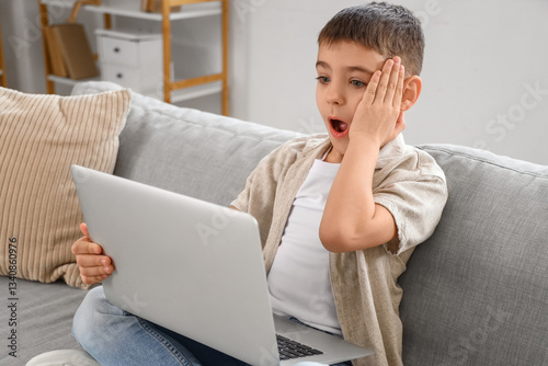 Shocked little boy with lap...
