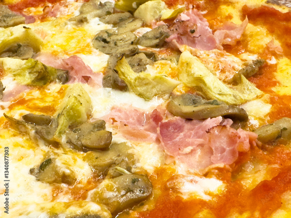 Delicious mushroom artichoke and ham pizza with melted mozzarella