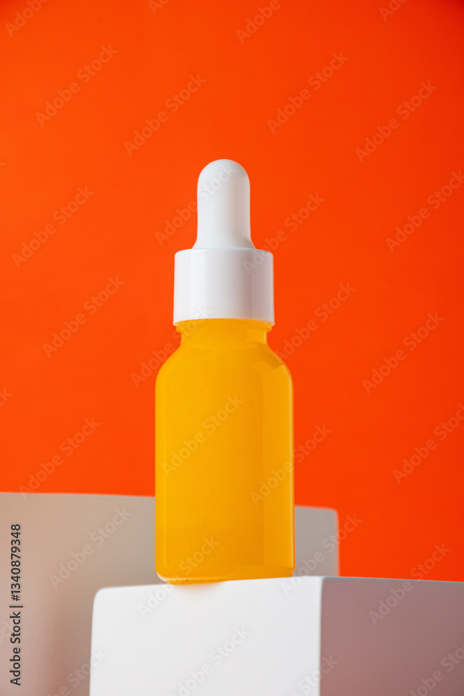 Plastic yellow tube for cream or lotion. Skin care or sunscreen cosmetic with stylish props on orange background. Plastic yellow tube for cream or lotion. Skin care or sunscreen cosmetic with stylish props on orange background.