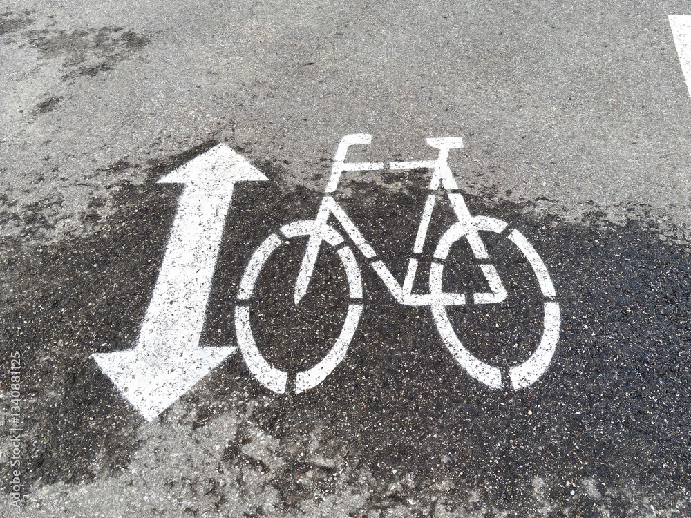 Bicycle lane sign on urban asphalt path symbolizing cycling direction Bicycle lane sign on urban asphalt path symbolizing cycling direction