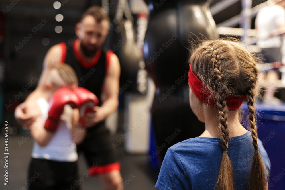 Girl at boxing practice in training center Girl at boxing practice in training center
