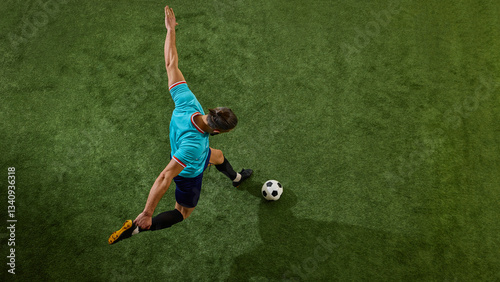 Vászonkép Elevated action shot of football athlete positioning body for decisive play, arms stretched, leg flexed, ready to impact game
